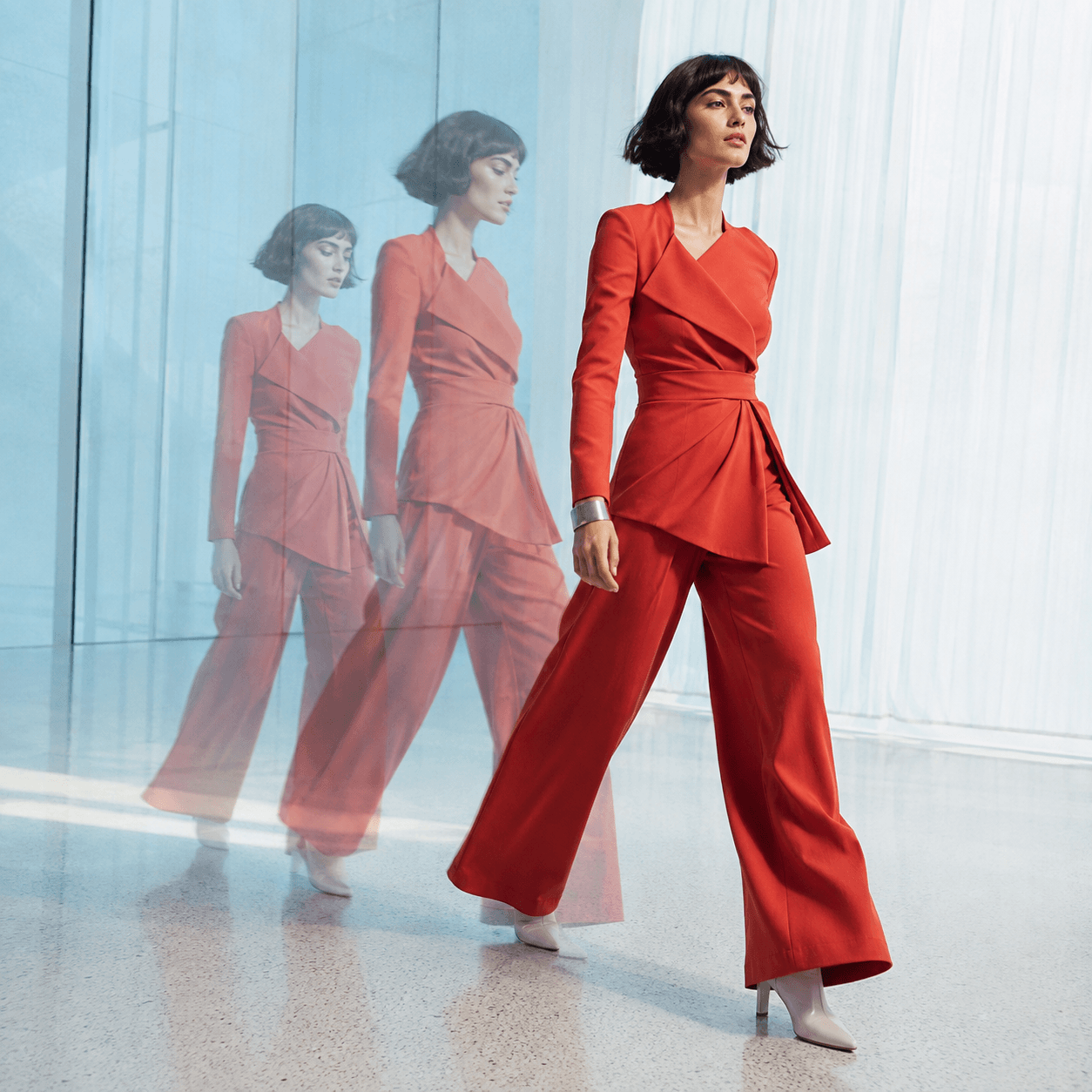 Adult fashion model in a red tailored suit shown through multiple exposures to represent consistent AI girl images across different poses.