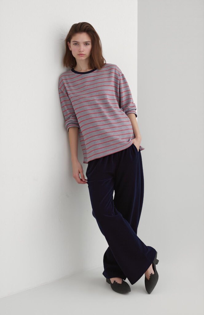 Model leaning against a wall with a relaxed posture, generated by AI pose tool from Weshop AI