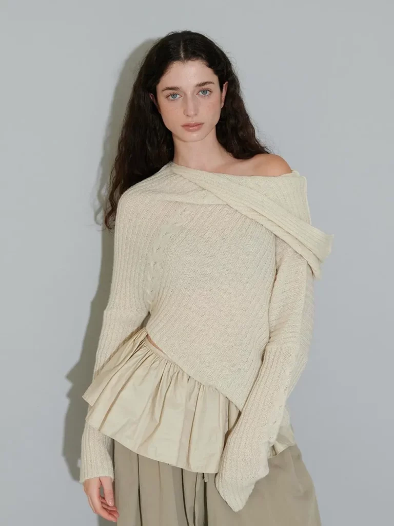 Original fashion portrait featuring cream layered knitwear and neutral trousers.