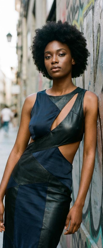 A high-fashion navy and leather cut-out dress shown as the target style for a virtual try-on and AI clothes changer session.