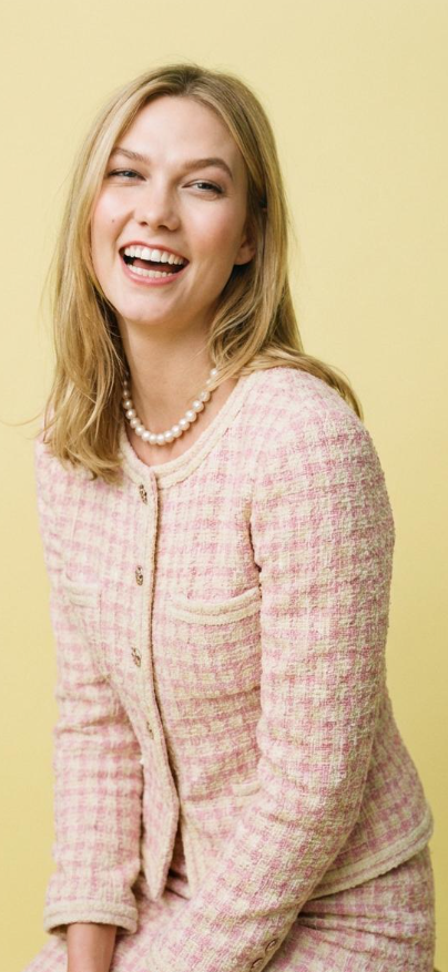 Original portrait of a smiling woman in a pink tweed suit set, ready to be processed by the AI clothes changer.