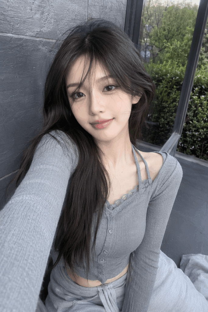 16 – WeShop AI Blog Casual daytime selfie of an East Asian woman wearing a grey cardigan, serving as a face reference for WeShop AI generation.