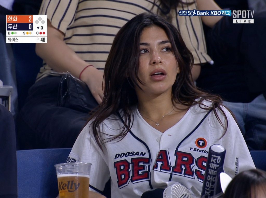 image – WeShop AI Blog Candid-style AI broadcast frame generated by gpt image2 featuring a female fan in the stadium crowd with realistic TV graphics.