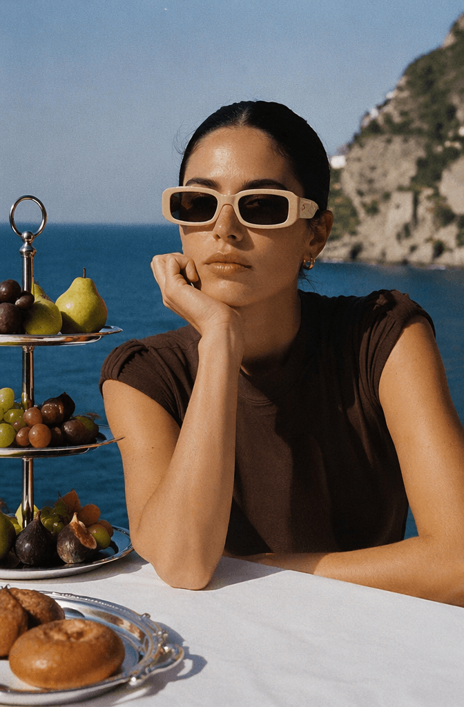 cb2 – WeShop AI Blog Portrait reference of a woman wearing sunglasses by the sea, used to preserve facial features, hairstyle, pose, and summer cinematic mood in the AI poster.