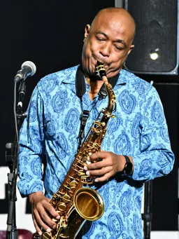 music4 – WeShop AI Blog AI-generated saxophone player performing on stage for a jazz-inspired music promotion visual.
