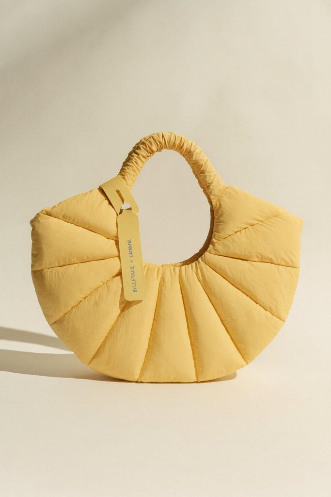 vb – WeShop AI Blog Yellow sculptural handbag product image showing shape and texture details for 360 product video creation