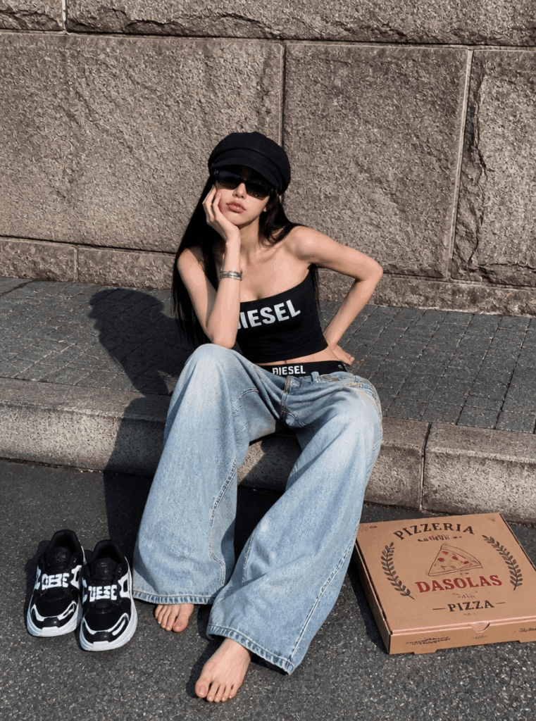 AI virtual try-on result showing a black crop top, baggy jeans, sunglasses, and casual street-style styling.