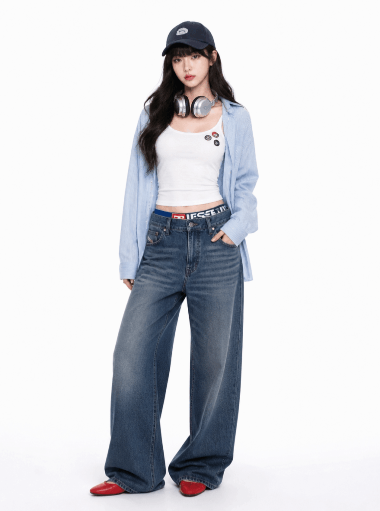 AI virtual try-on result showing a relaxed denim outfit with a white tank top, light blue shirt, wide-leg jeans, and cap.