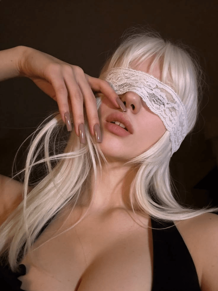 赛博11 – WeShop AI Blog Original portrait of a blonde woman wearing a lace blindfold, used as the base photo for a cyber angel AI anime portrait.