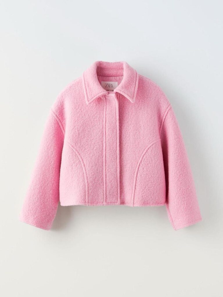 Clean pink cropped jacket image with clear sleeves, collar, and fabric details.