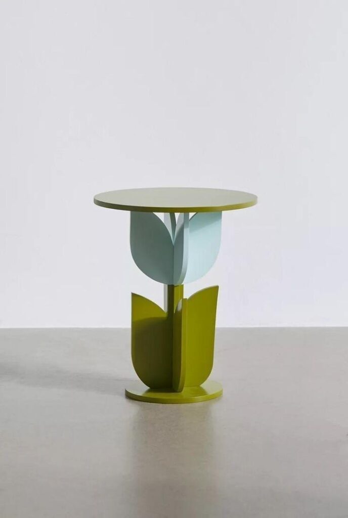 Colorful flower-shaped side table photographed alone against a clean light studio background.
