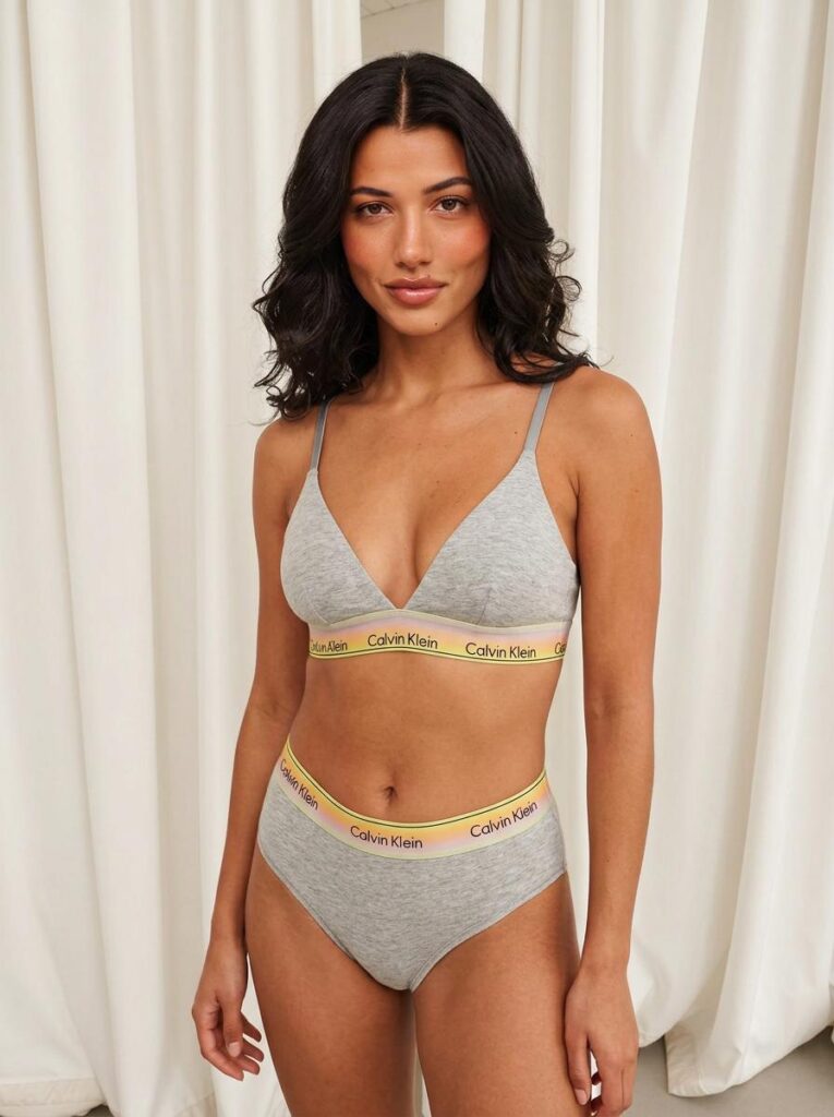 6a42296c97e68c8b4f063868_final – WeShop AI Blog Adult model wearing a light gray lingerie set generated with an AI Lingerie Generator in a bright indoor setting.
