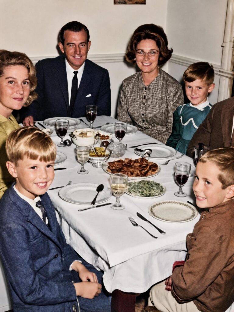 AI Photo Restoration result showing the family dinner photograph with repaired damage, clearer faces, improved contrast, and natural colors.