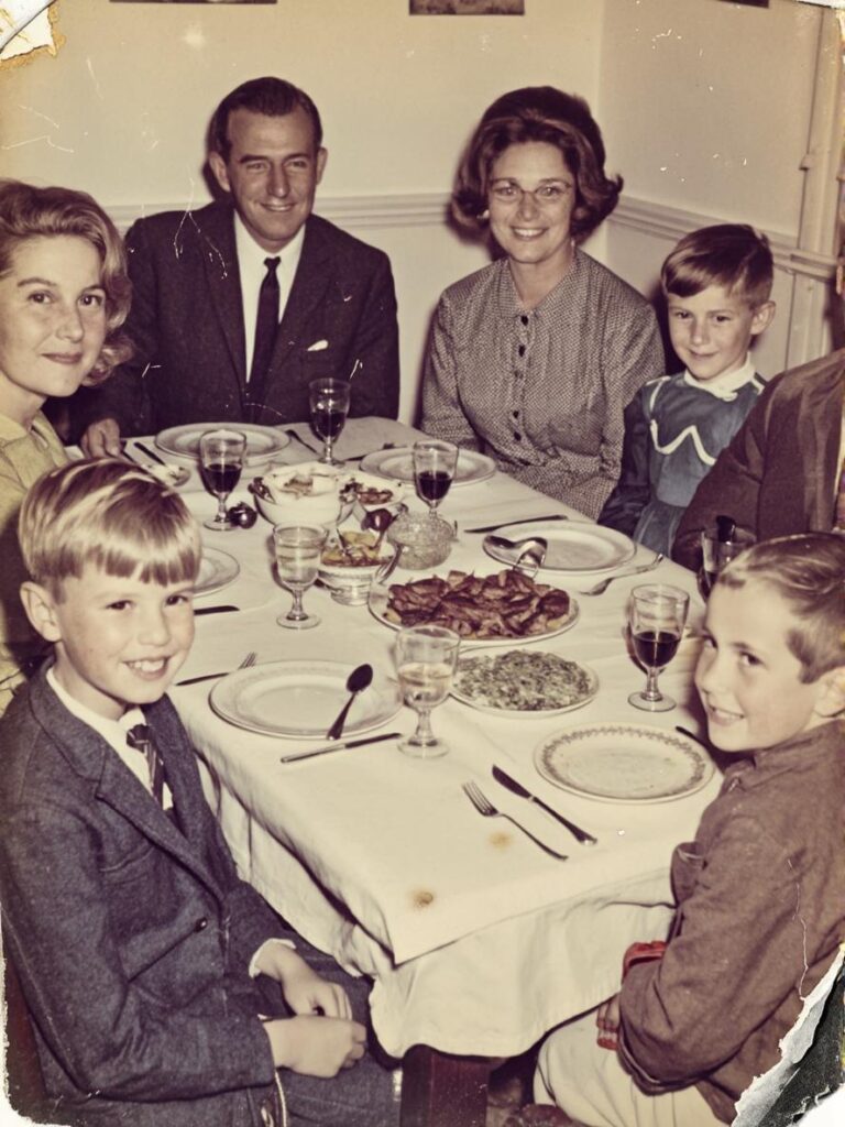 Damaged vintage family dinner photograph with faded colors, scratches, dust, worn edges, and reduced facial clarity.