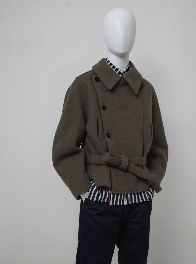 ai-mannequin-generator-guide-02-02 – WeShop AI Blog Olive green belted jacket displayed on a white mannequin after AI mannequin conversion.