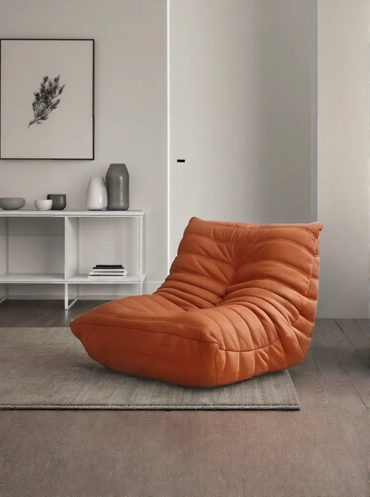 Orange lounge chair with additional background space created by AI Image Expander.