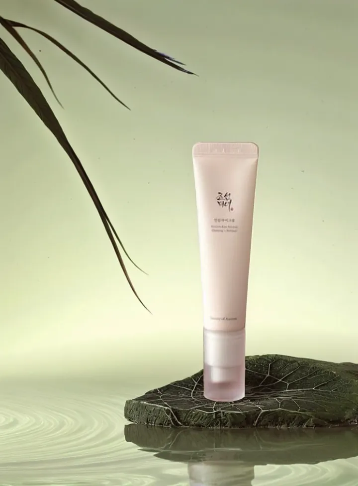 magic-eraser-guide-01-01 – WeShop AI Blog Pink skincare tube displayed on a dark stone platform with distracting branches extending into the upper-left background.