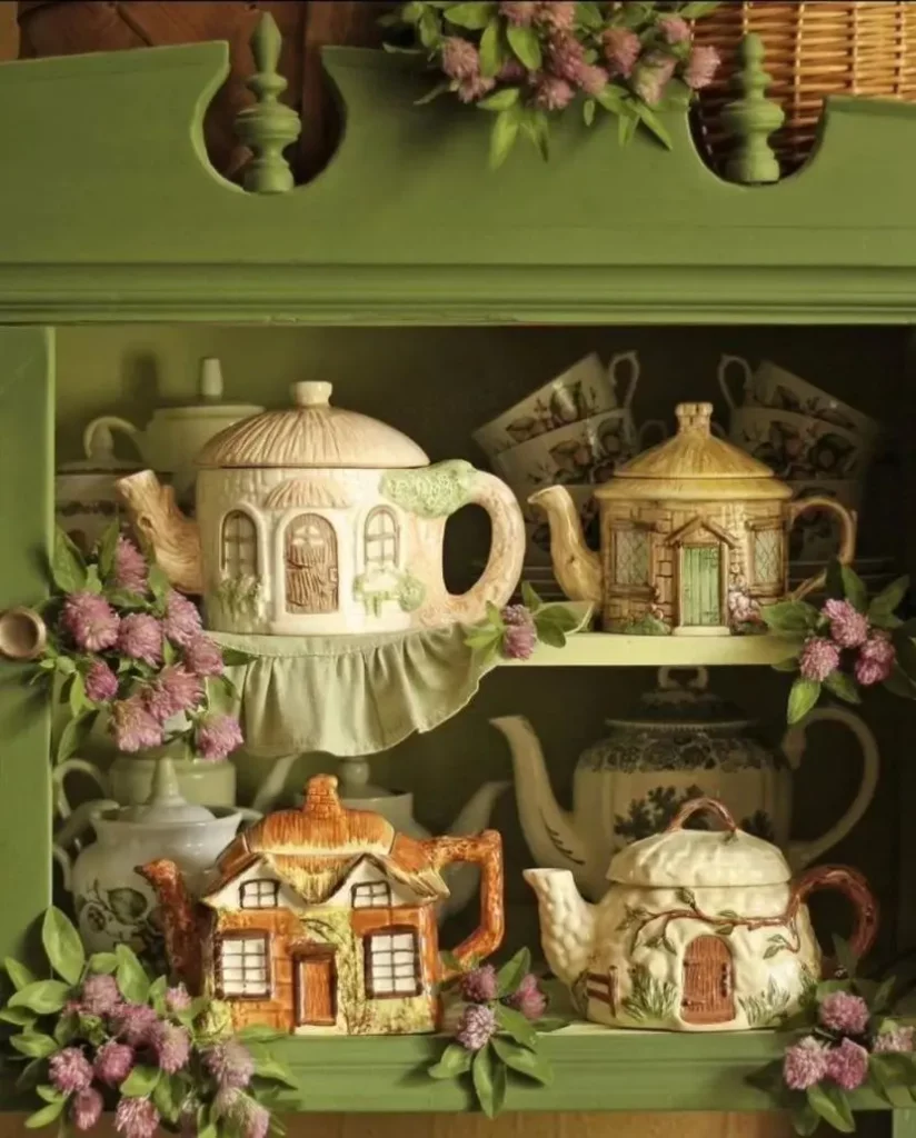 sdt – WeShop AI Blog Vintage green cabinet displaying decorative house-shaped teapots surrounded by flowers.