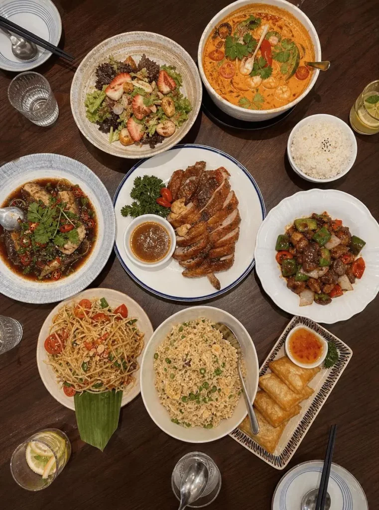 47996df1-c82f-427c-8563-8a84cd574bd1_880x1184png_preview – WeShop AI Blog Overhead photo of a dining table filled with Thai dishes before Japanese Hand-Drawn Plog annotations are added.