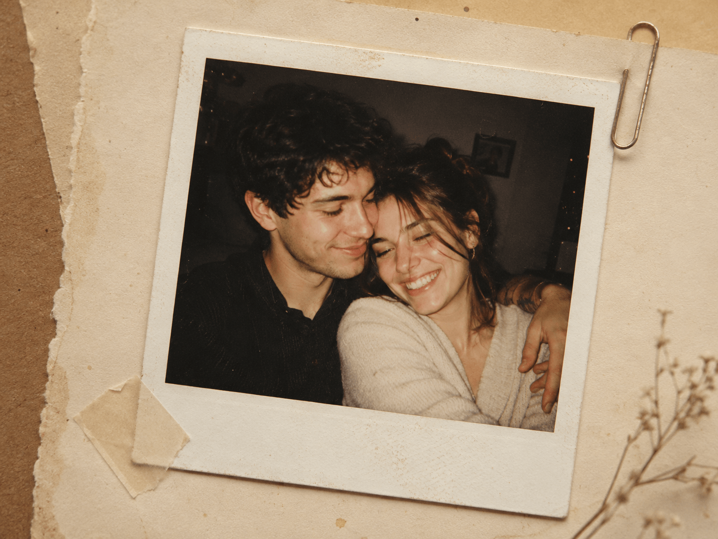 Warm Polaroid Couple Photo cover featuring a smiling couple surrounded by vintage instant photos, handwritten notes, dried flowers, paper clips, and scrapbook textures.