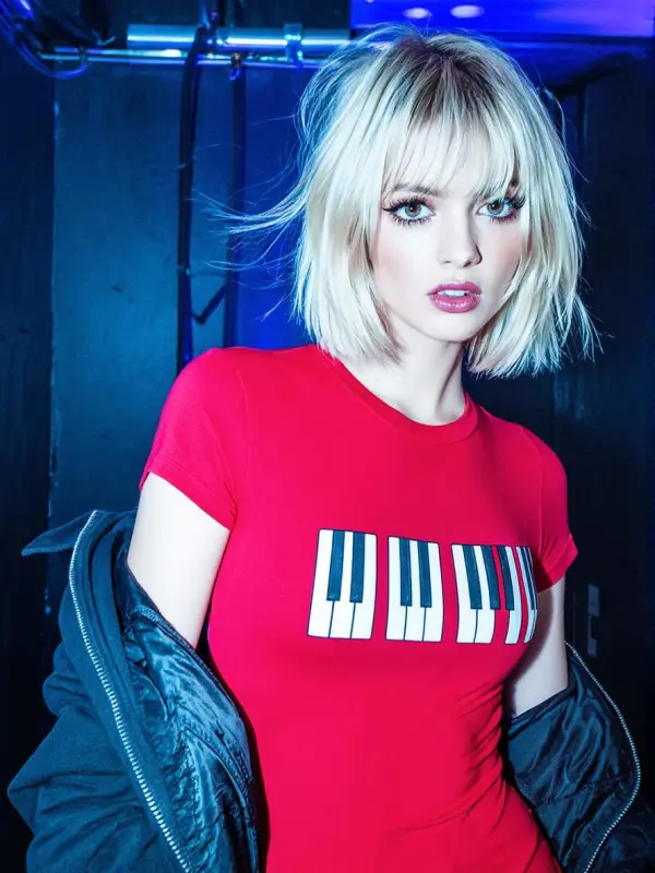 jm – WeShop AI Blog Portrait of a blonde woman in a red piano-key T-shirt under blue neon lighting